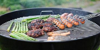 Würstchen und Spargel auf einem Gittergrill