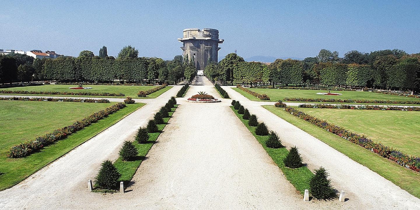 Flagturm im Augarten Wien, davor heller Weg mit grünen Bäumen umgeben